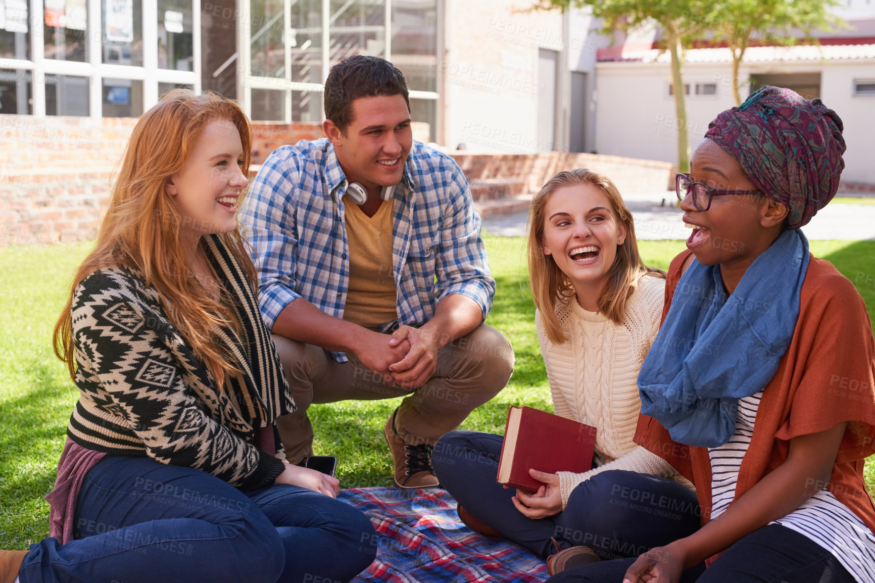 Buy stock photo Shot of a group of young friends having their study session outside