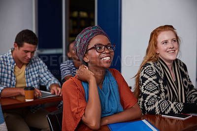 Buy stock photo Cropped shot of a group of university students sitting in class