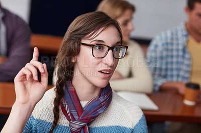 Buy stock photo Cropped shot of a university student raising her hand in class