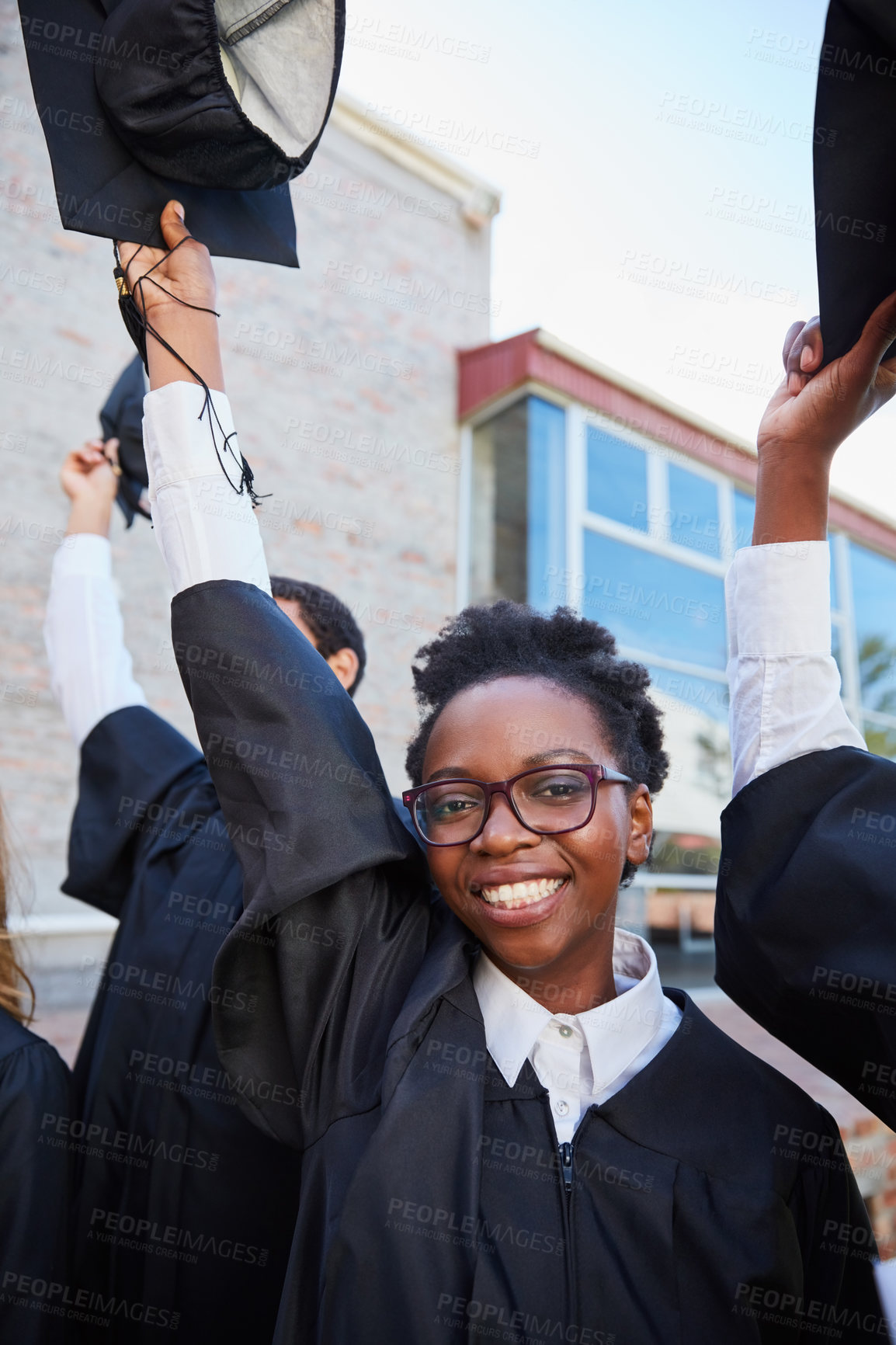 Buy stock photo Portrait of a happy female student standing outside on her graduation day