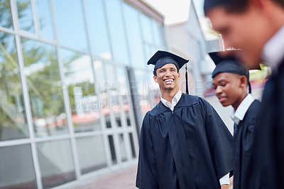 Buy stock photo Shot of a happy group of students standing outside on their graduation day