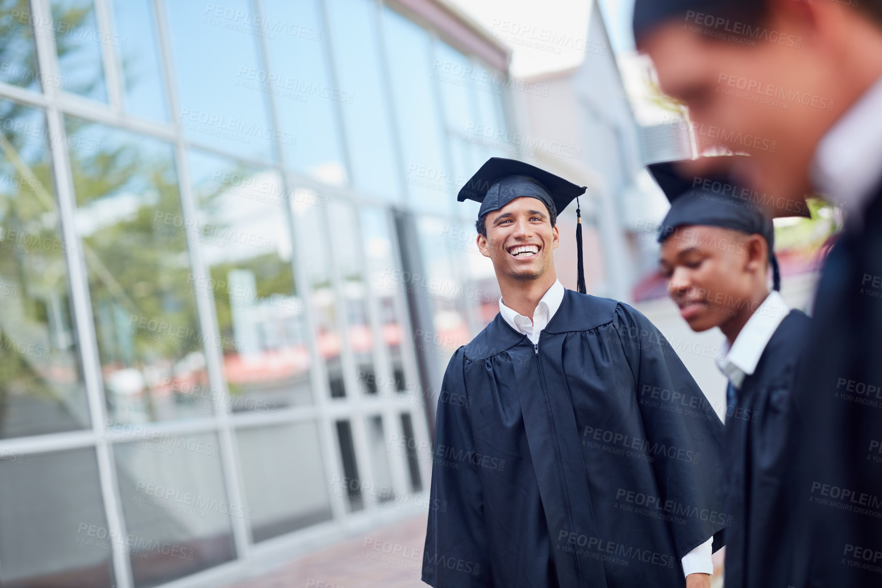 Buy stock photo Shot of a happy group of students standing outside on their graduation day