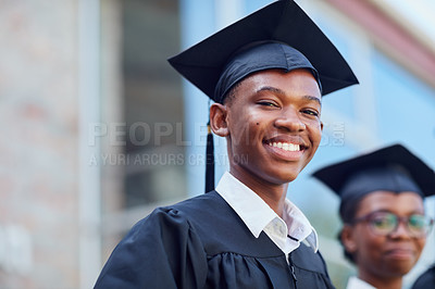 Buy stock photo Portrait of a happy male student standing outside on his graduation day