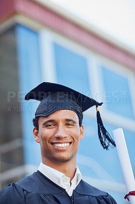 Buy stock photo Portrait of a happy male student standing outside on his graduation day