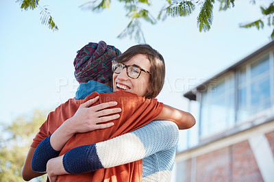Buy stock photo Cropped shot of two university students hugging each other