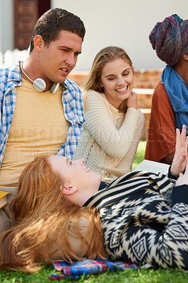 Buy stock photo Shot of a student relaxing outside with her friends
