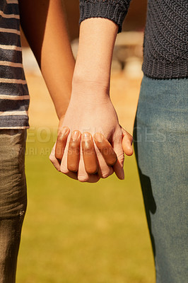 Buy stock photo Cropped shot of a couple holding hands
