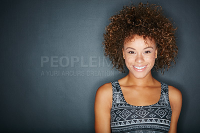 Buy stock photo Studio shot of a happy woman posing against a dark background