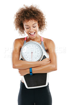 Buy stock photo Studio shot of a fit young woman embracing a scale against a grey background