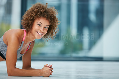 Buy stock photo Shot of a fit young woman doing push-ups in a studio