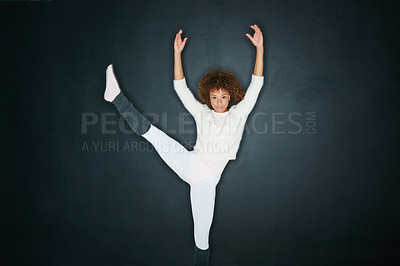 Buy stock photo Studio shot of an attractive young woman dancing against a gray background