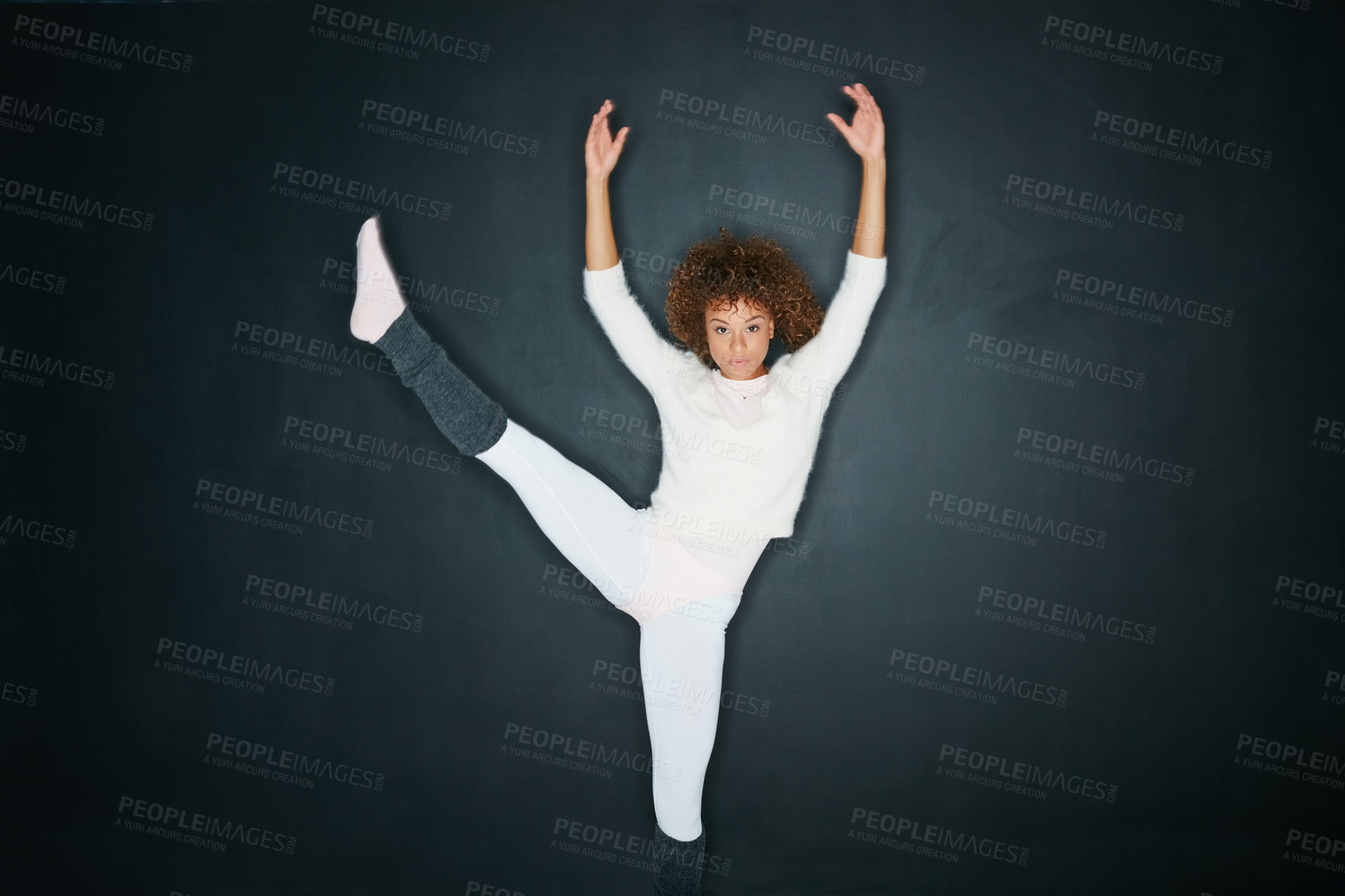 Buy stock photo Studio shot of an attractive young woman dancing against a gray background