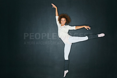 Buy stock photo Studio shot of an attractive young woman dancing against a gray background