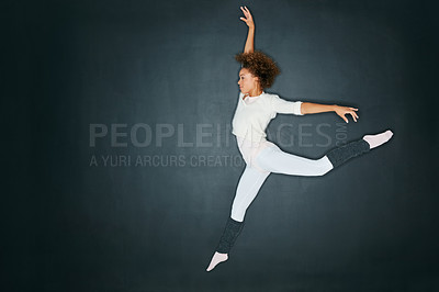 Buy stock photo Studio shot of an attractive young woman dancing against a gray background