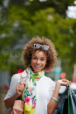 Buy stock photo Portrait of an attractive young woman on a shopping spree in the city