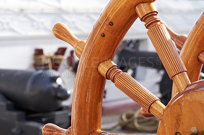 Buy stock photo Outdoor, ship and wood steering wheel at ocean for sailing, transportation and travel. Harbor, marine and war or sailboat in closeup for luxury, adventure and trip or journey with cruise and navigate