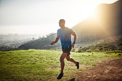 Buy stock photo Shot of a young runner training outdoors