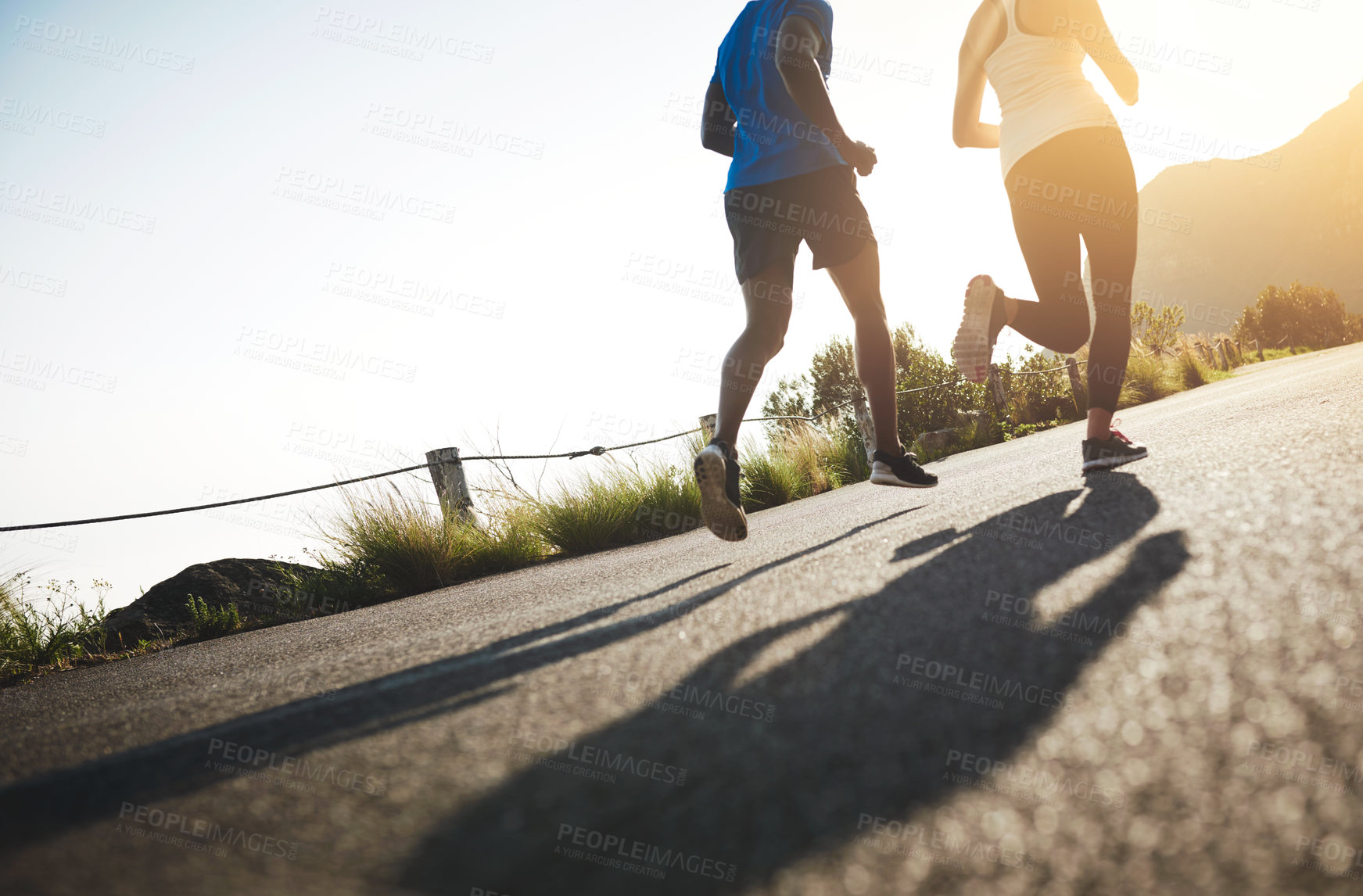 Buy stock photo Sports, running and people with workout in nature for fitness, support or cardio in wellness training. Low angle, friends and runner with athlete by road for endurance, challenge or exercise together