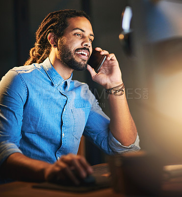 Buy stock photo Cropped shot of a young designer talking on a cellphone while working late in an office