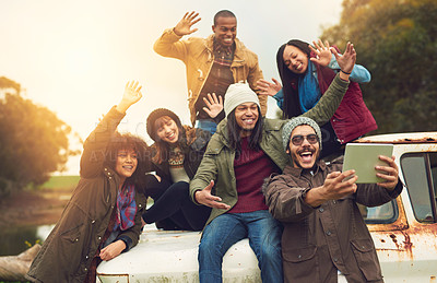 Buy stock photo Shot of a group of friends posing for a selfie while having fun outside