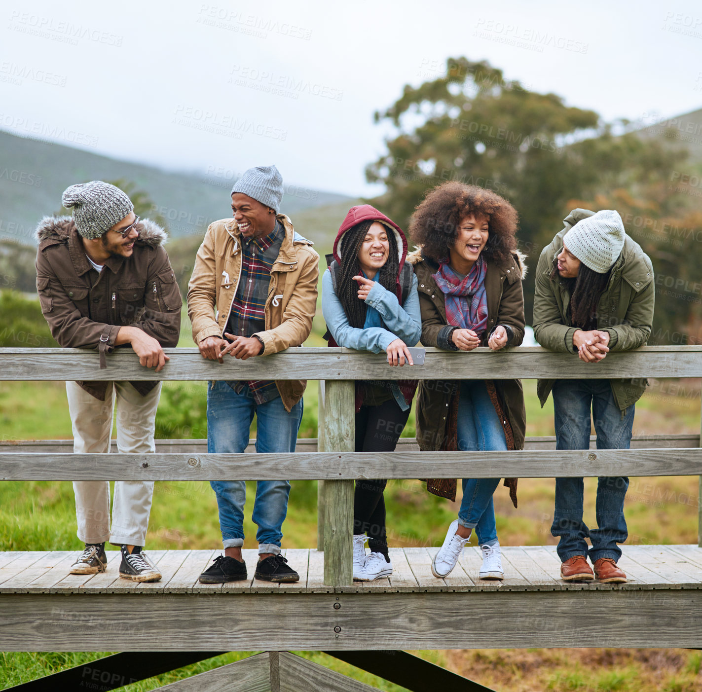 Buy stock photo Friends, bridge and outdoor conversation in nature, autumn holiday and countryside for bonding. People, diversity and laugh for funny joke together in woods, vacation and humor on trip to Costa Rica