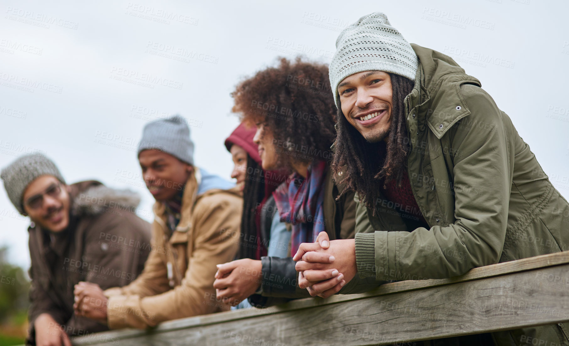 Buy stock photo Outdoor, bridge and portrait of man with friends in nature for autumn holiday in countryside for bonding. Happy, diversity and male person with group in woods on vacation, weekend trip or getaway.