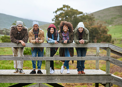 Buy stock photo Portrait of a group of friends posing on a wooden bridge together