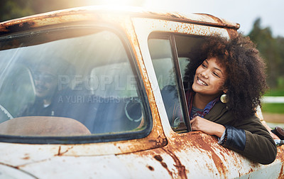 Buy stock photo Shot of a happy young woman sitting in a rusty old truck