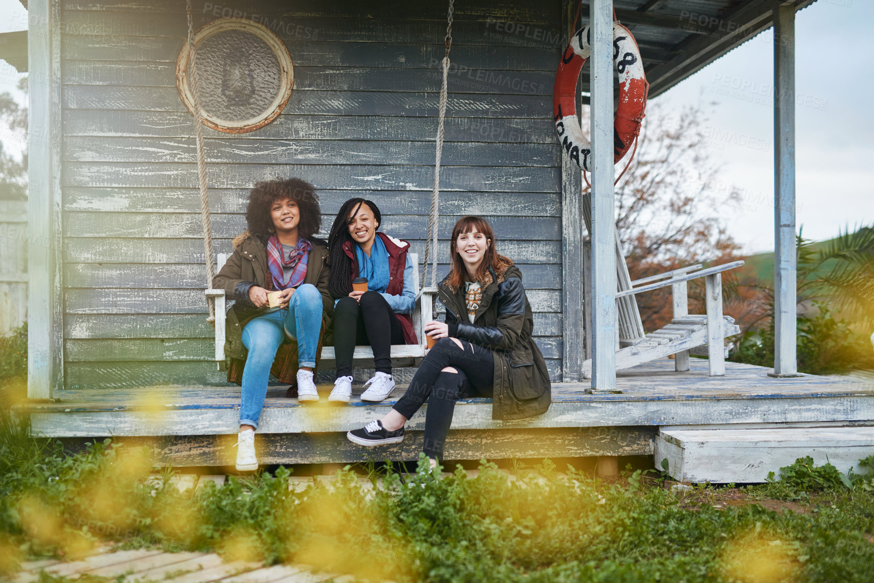 Buy stock photo Nature, friends and portrait of women at cabin with smile, holiday adventure and bonding on lake house porch. Outdoor, winter fun and happy people relax on cottage patio for travel vacation together