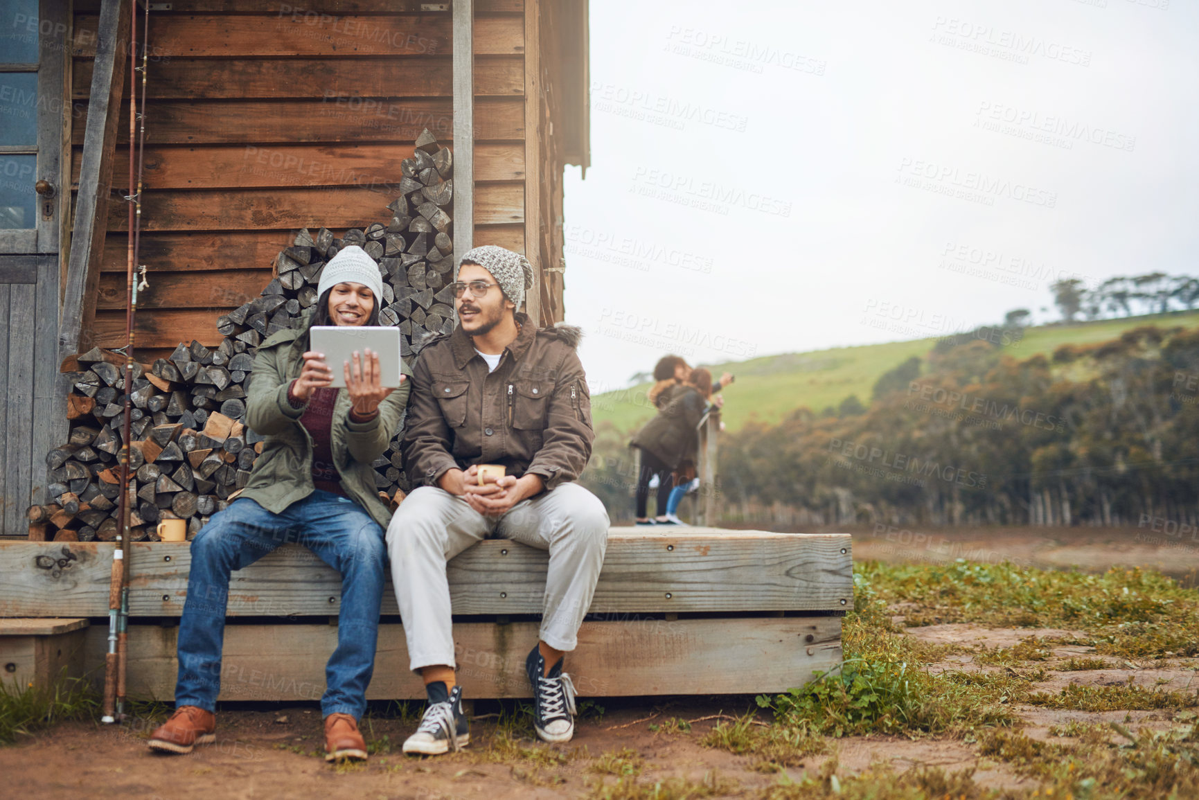 Buy stock photo Happy man, friends and camping with tablet on patio in nature for connectivity, signal or browsing. Male people, relax or campers with technology for entertainment at holiday house in countryside