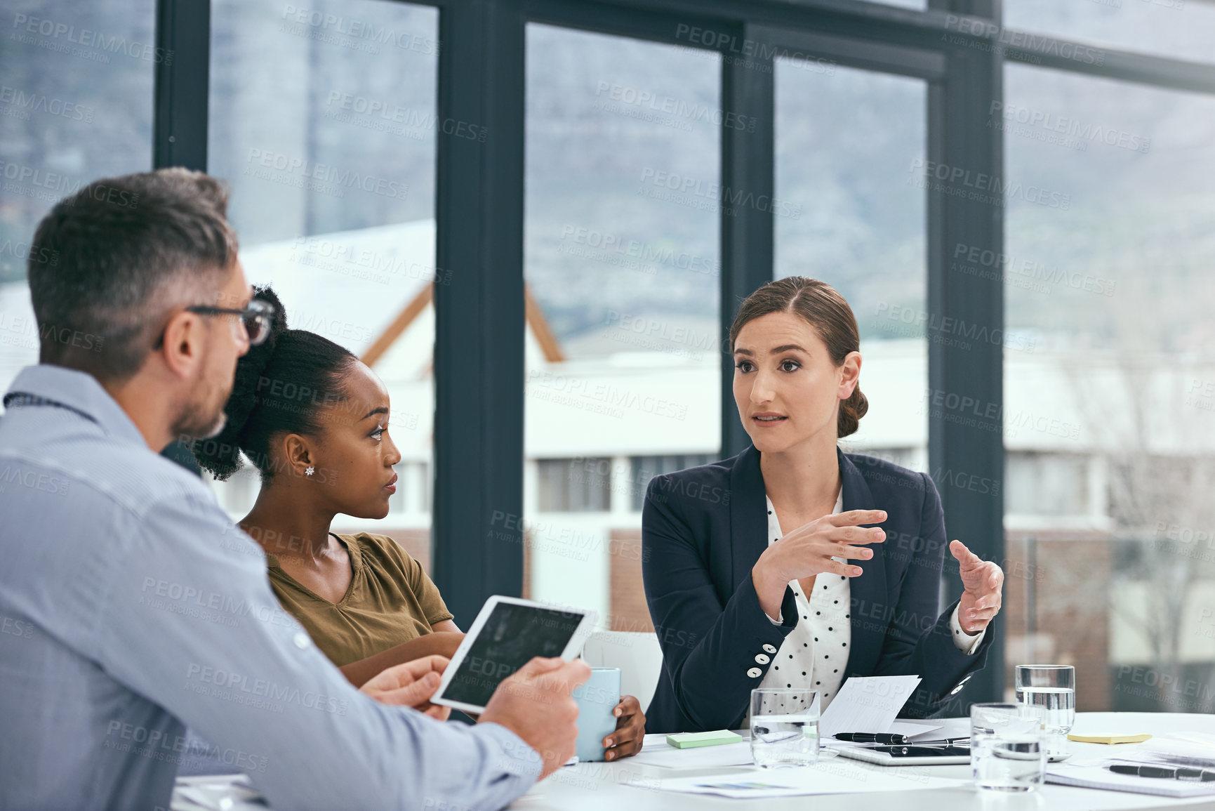 Buy stock photo Cropped shot of a group of colleagues having a meeting in an office