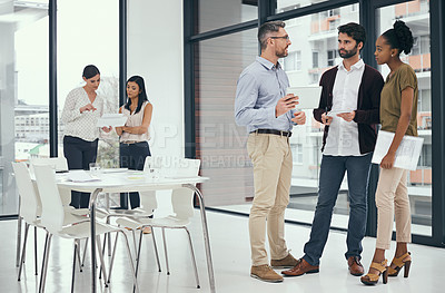 Buy stock photo Shot of a group of colleagues having a discussion in an office