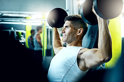 Buy stock photo Shot of a man doing a upper-body workout at the gym