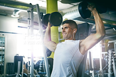 Buy stock photo Shot of a man doing a upper-body workout at the gym