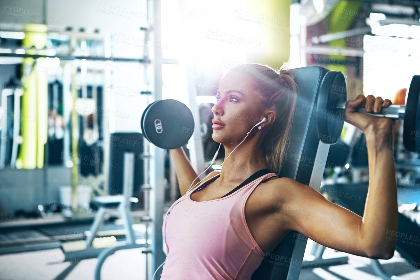 Buy stock photo Shot of a woman doing a upper-body workout at the gym