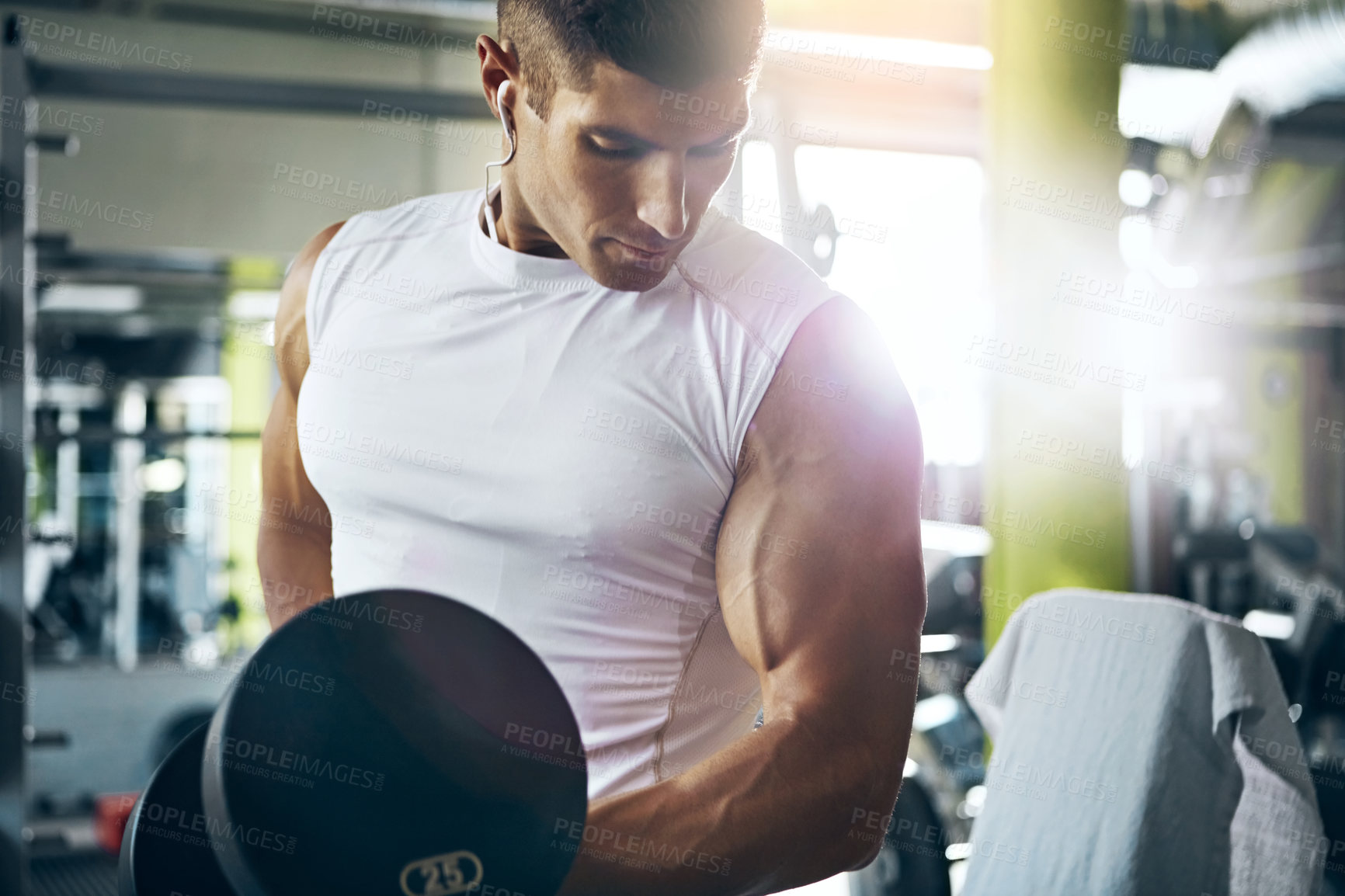 Buy stock photo Shot of a man doing a upper-body workout at the gym