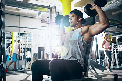 Buy stock photo Shot of a man doing a upper-body workout at the gym