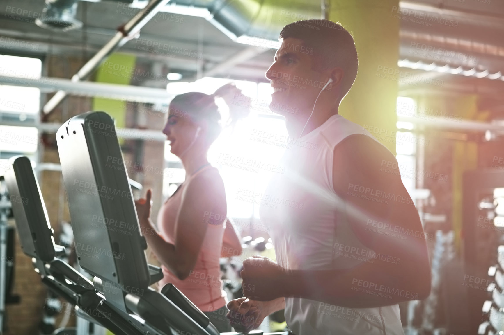 Buy stock photo Shot of a man and a woman working out together in the gym