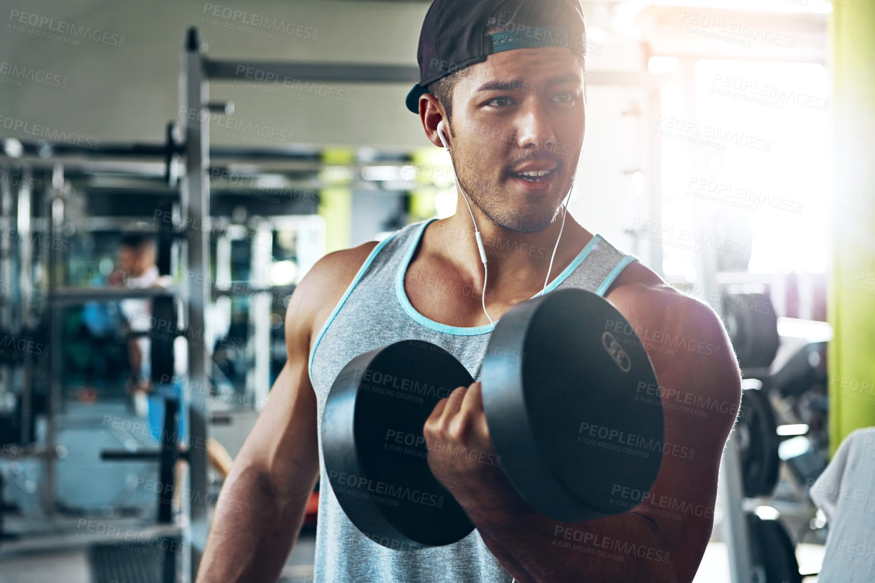 Buy stock photo Shot of a man doing weight training at the gym