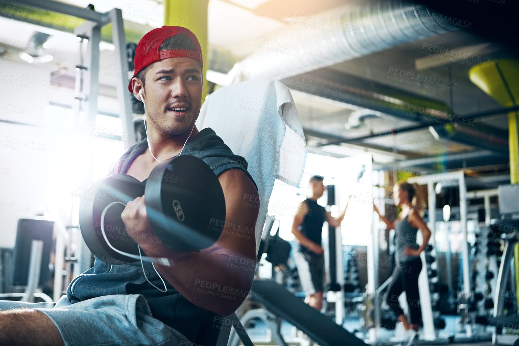 Buy stock photo Shot of a man doing a upper-body workout at the gym