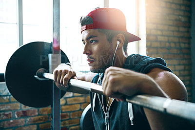 Buy stock photo Shot of a man doing weight training at the gym