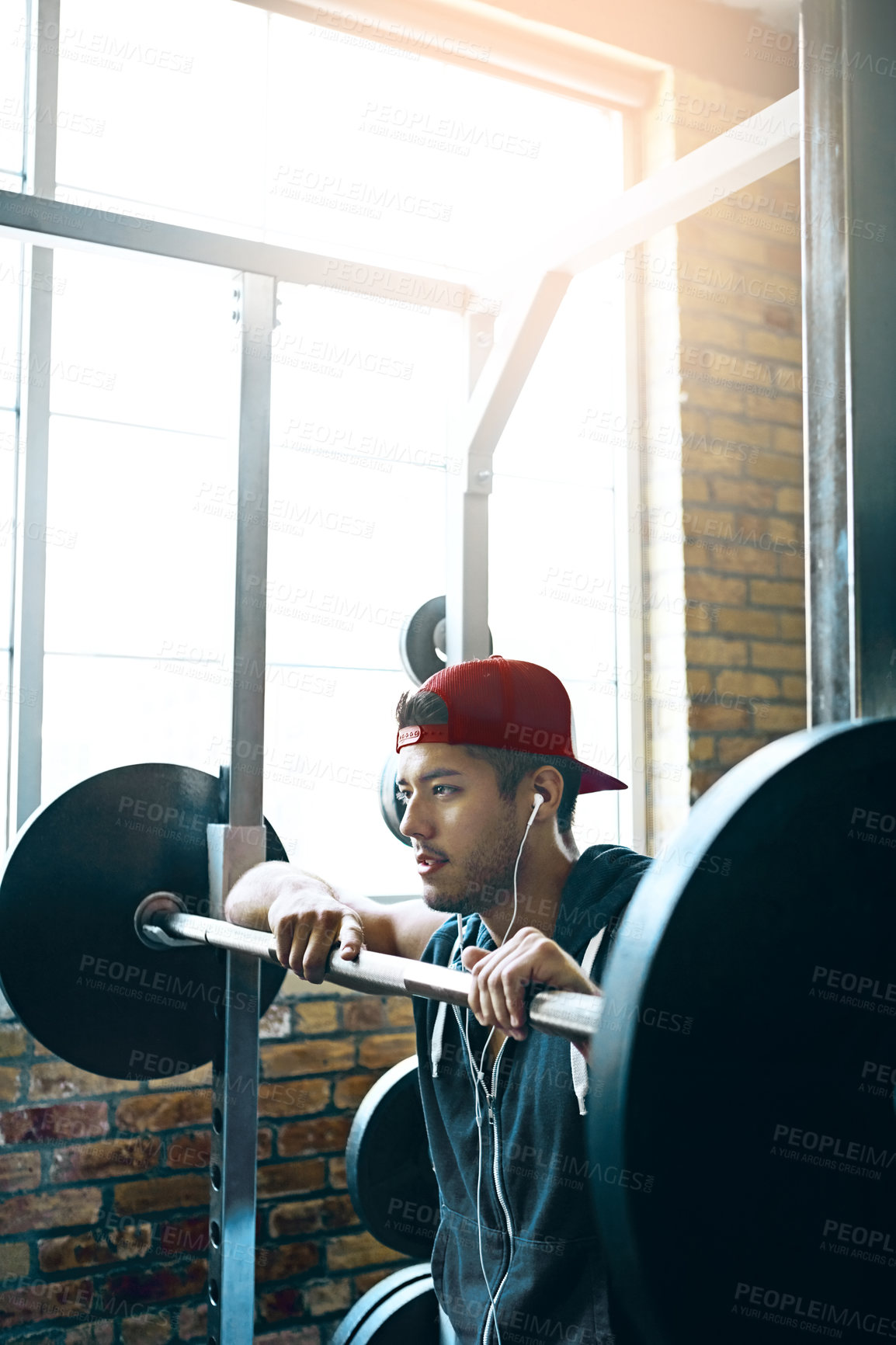 Buy stock photo Shot of a man doing weight training at the gym