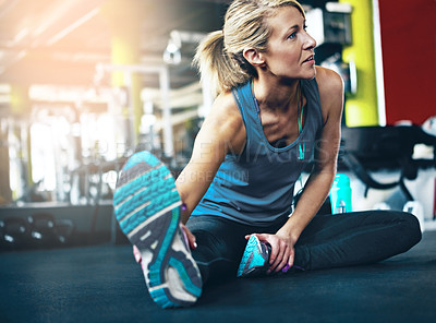 Buy stock photo Shot of a sporty woman working out at the gym