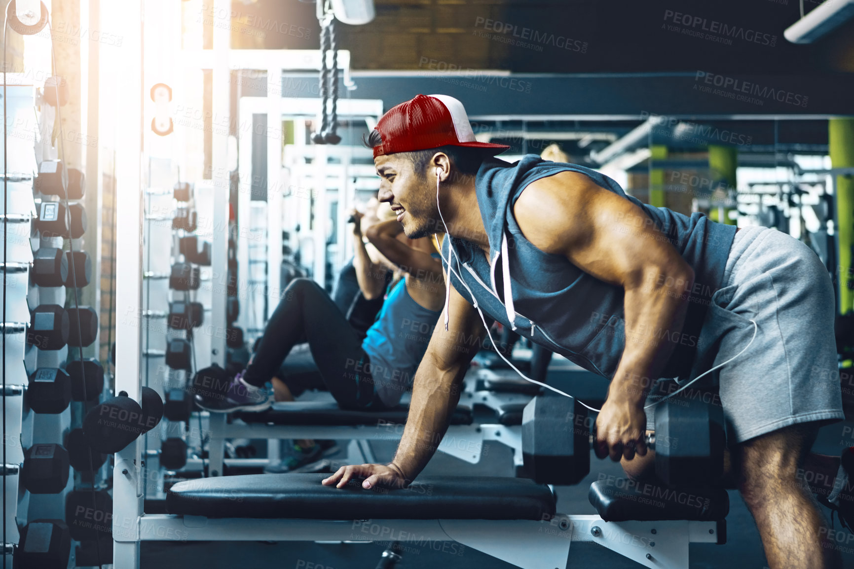 Buy stock photo Intense, dumbbells and man in gym, training and endurance for body development. Equipment, weight lifting or person in wellness center, energy or fitness for muscle growth, power and core workout