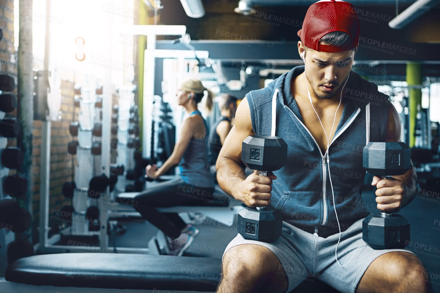 Buy stock photo Shot of a man doing a upper-body workout at the gym