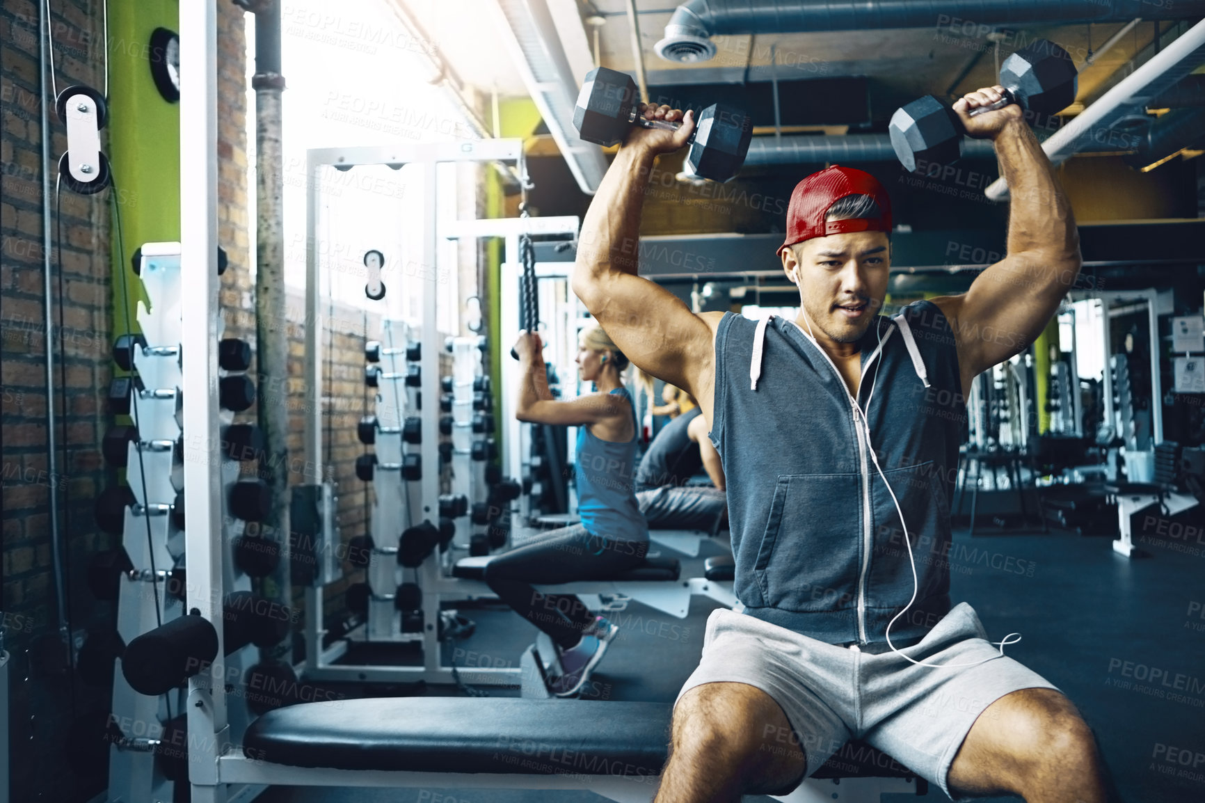 Buy stock photo Shot of a man doing a upper-body workout at the gym