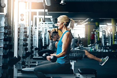 Buy stock photo Shot of a sporty woman working out at the gym