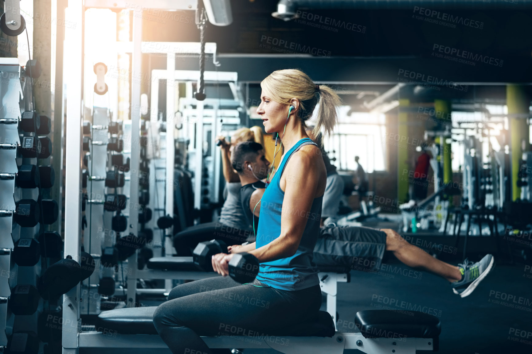 Buy stock photo Shot of a sporty woman working out at the gym