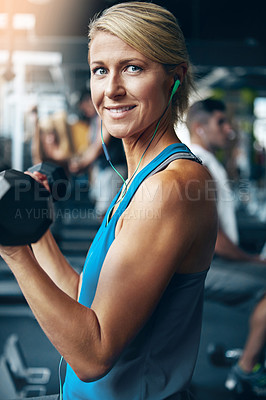 Buy stock photo Shot of a woman doing weight exercises at the gym