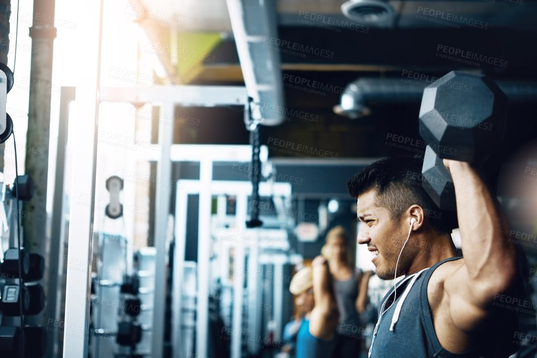 Buy stock photo Shot of a man doing weight training at the gym